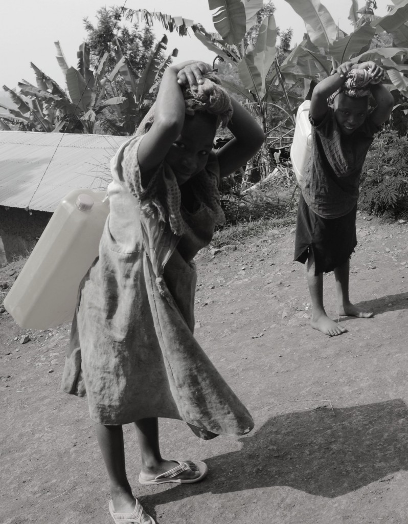 Two young girls from Kivu lake to fetch water. it was a 5 km journey carry such water