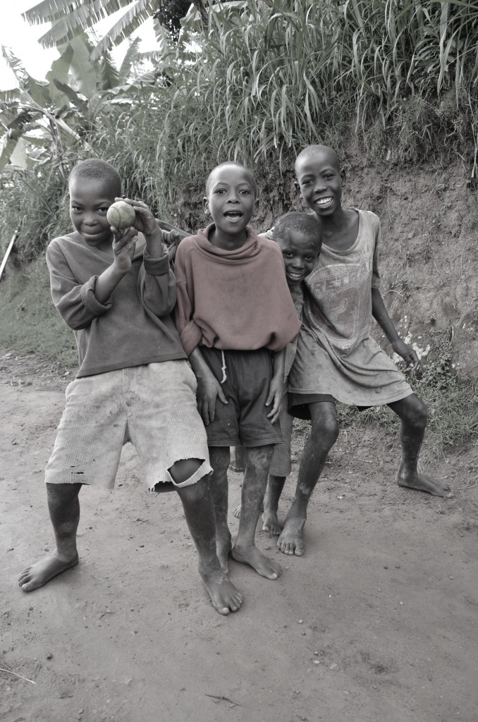 Three young boys from Karongi playing the ball