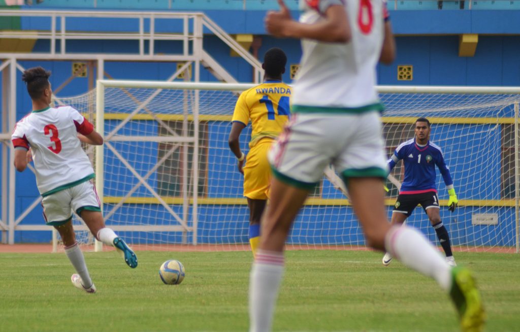 Ian Kagame No 14, running to approach the ball , as Morroco defenders stay tough to be broken