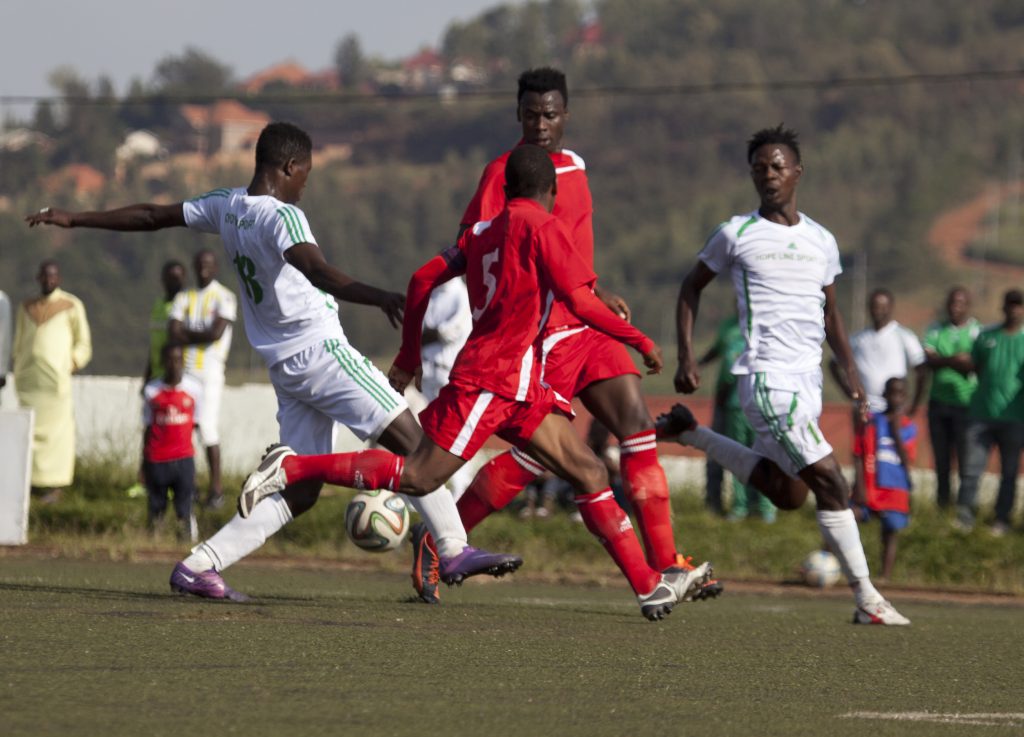 SC Kiyovu 's midifielders in full controls of the ball to eliminate Espoir Fc defenders