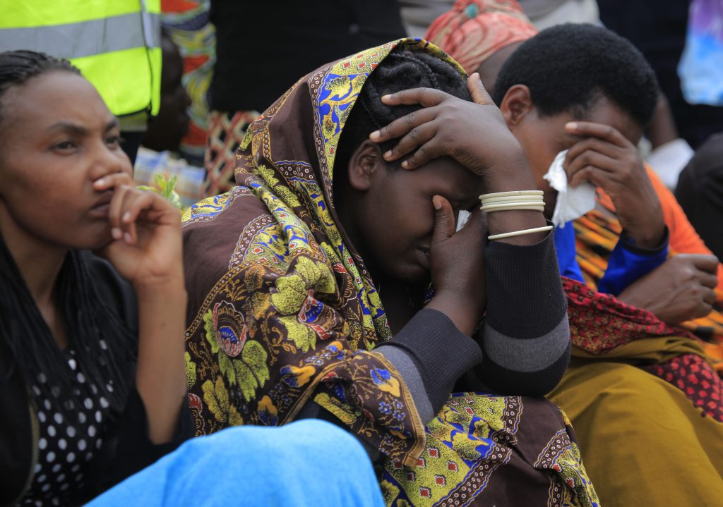 A genocide survivor in shock as she hears the testimony of the Tutsi slaughtered at Murambi in French military camp